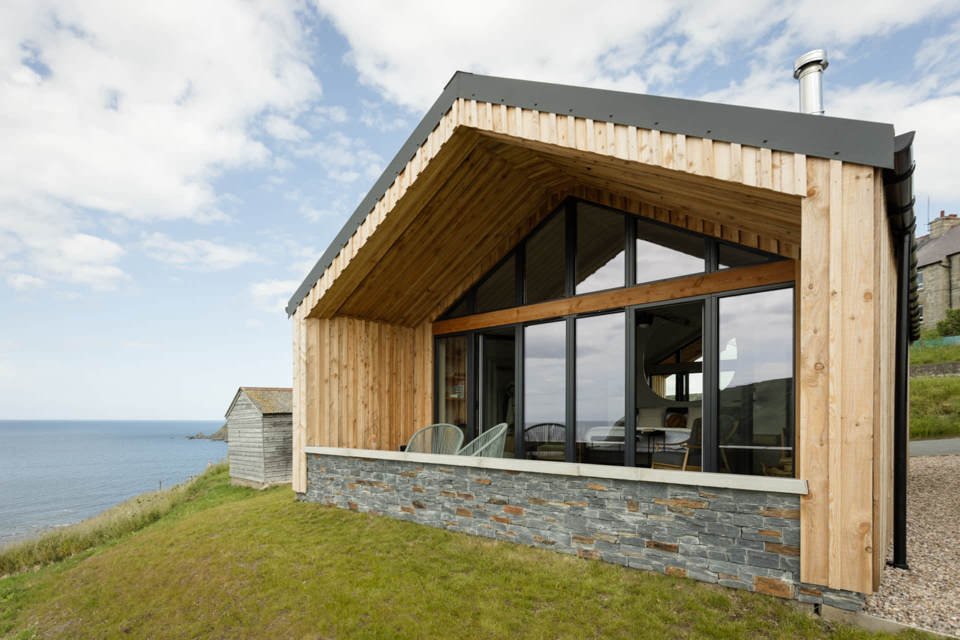 Muckle View's glazed gable end and terrace looking out to the Moray Firth.